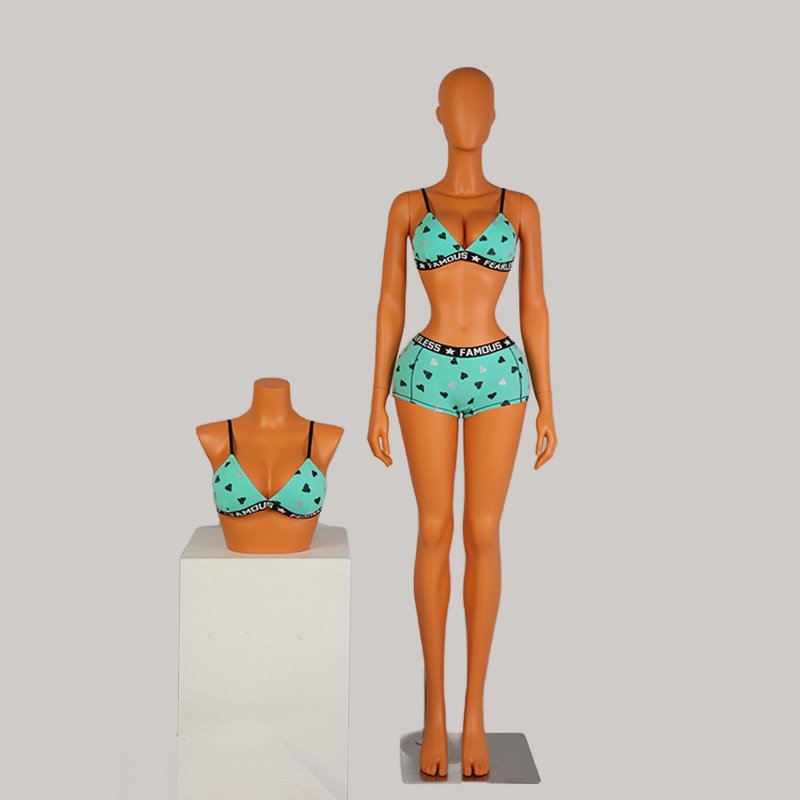 a mannequin wearing a blue garment and a white box